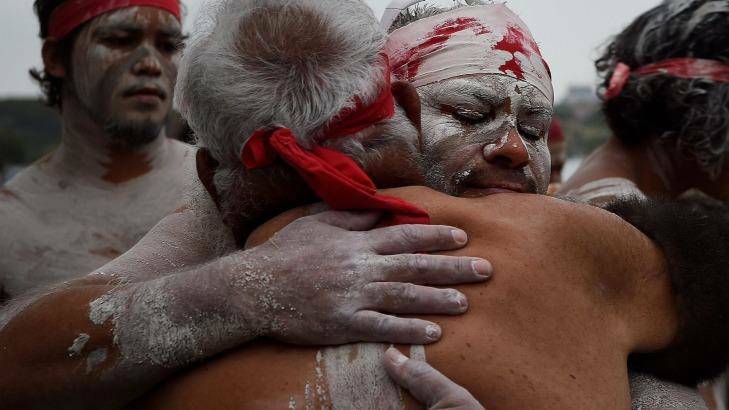 Members of the Koomurri Aboriginal Dance Troup embrace. Photo: Kate Geraghty