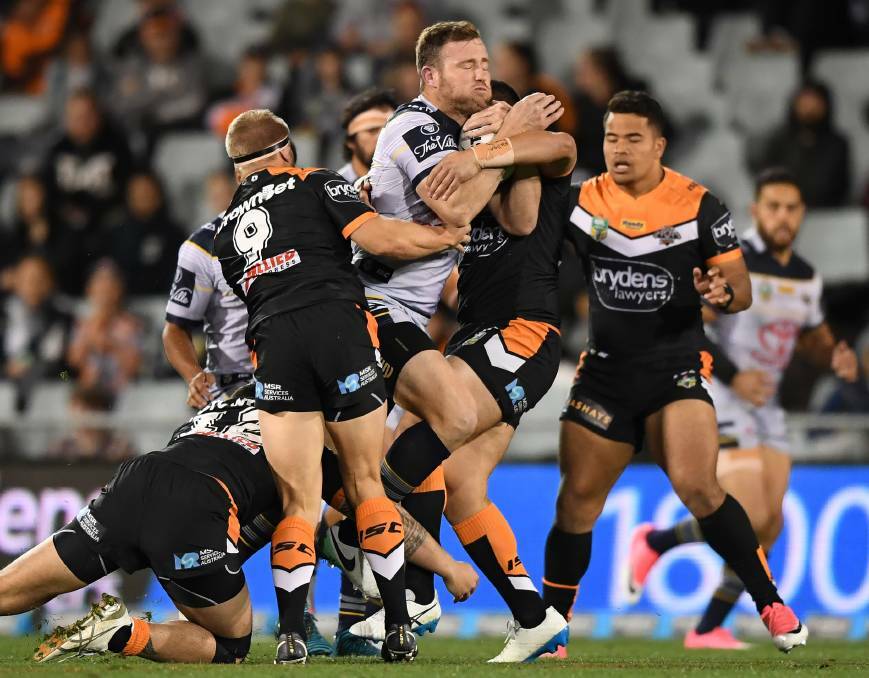 Wests Tigers player tackle North Queensland's Gavin Cooper during the round 25 match played at Campbelltown Sports Stadium. Picture: AAP Image/David Moir