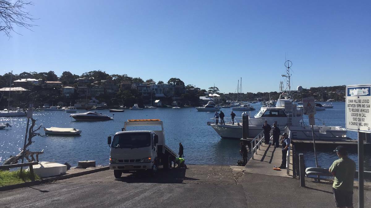 Emergency response: A tow truck arrives at the scene after a car went into water at Dolans Bay today. Picture: Chris Lane
