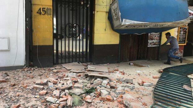 A man enters a damaged building after an earthquake in Mexico City. Photo: AP