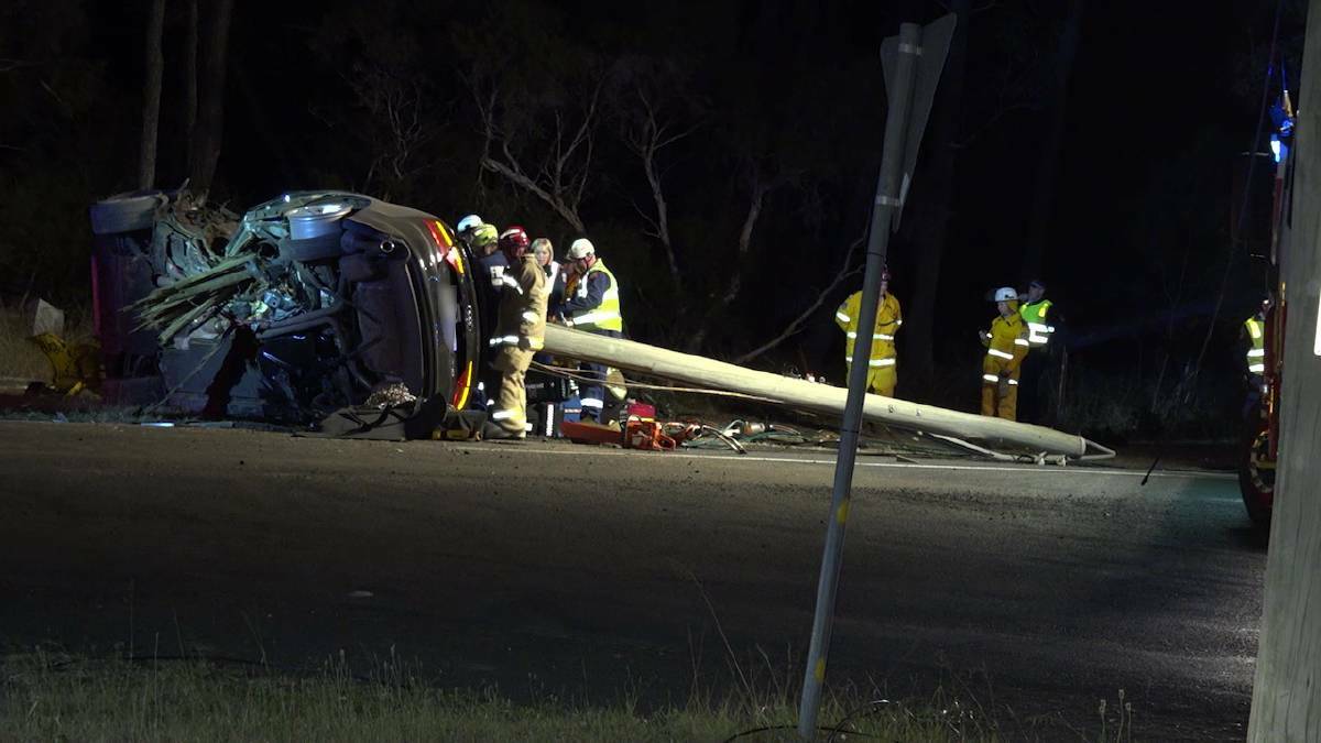 FATAL CRASH: One man is dead and another injured after this sedan left the road and struck a power pole, bringing down lines, on Sunday. A man has since been charged in relation to the crash. Picture: TNV