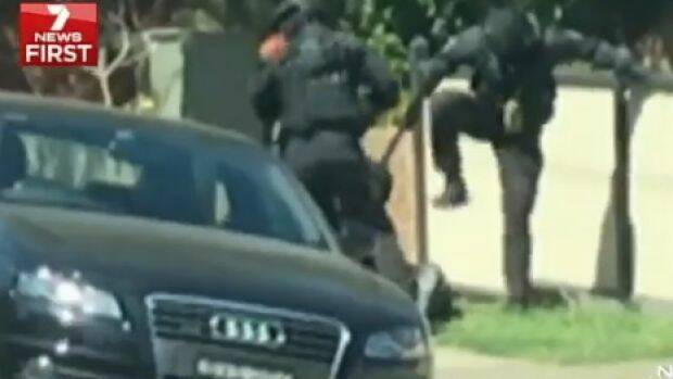 The footage showed on officer stomping the loaded gun from the hands of one of the men.  Photo: Seven News