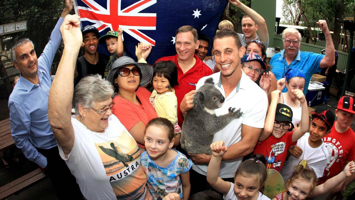 Blacktown mayor Stephen Bali and Featherdale Wildlife Park curator Chad Staples celebrate Australia Day with Archer the koala and local residents. Picture: Isabella Lettini