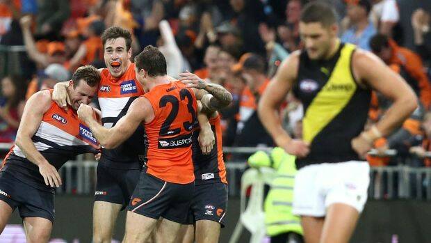 Out of jail: Jeremy Cameron and teammates celebrate the GWS Giants' comeback win against Richmond on Saturday night. Photo: Ryan Pierse