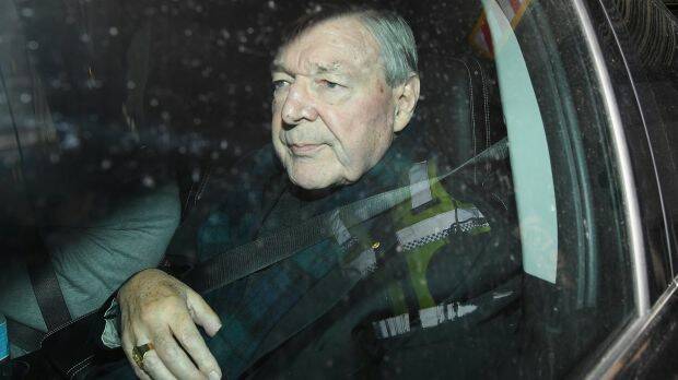 Cardinal George Pell departs after appearing in the Melbourne Magistrates Court. The gold ring given to him by Pope John II visible on his hand. Photo: AAP
