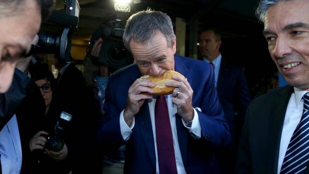 The controversial moment as Bill Shorten bites into a sausage sizzle...from the side. Photo: Andrew Ellinghausen