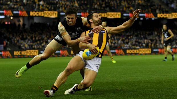 Collared: Marc Murphy stops Paul Puopolo, albeit illegally, on the way to Carlton’s first win over Hawthorn since 2005. Photo: AAP