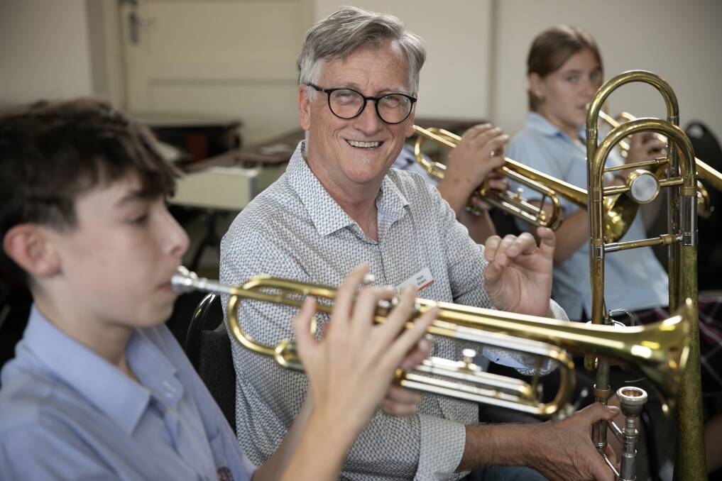 Mark Brown plays a tune with students from St Patrick's College. Picture supplied