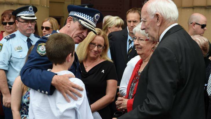 NSW Police Commissioner Andrew Scipione, comforts the wife of slain police officer Bryson Anderson, Donna, along with her son Cain and Bryson's parents Shirley and Rex as they leave the Supreme Court in Sydney on Thursday. Photo: Dan Himbrechts