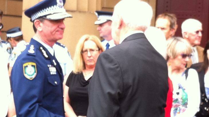 NSW Police Commissioner Andrew Scipione comforts the family of murdered policeman Bryson Anderson outside the court on Thursday.