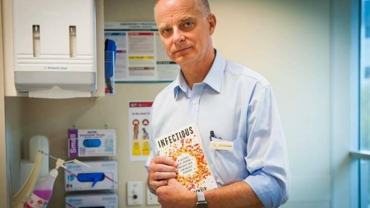 Professor Frank Bowden with a copy of his book, 'Infectious'. Photo: Elesa Kurtz