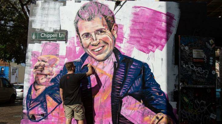Artist Scott Marsh paints a mural of NSW Premier, Mike Baird holding a kebab and glass of wine. Initiatives by the Baird government, such as a recent roundtable to develop policies for improving the city's night life, have been welcomed by businesses. Photo: Cole Bennetts