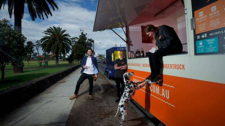 Jack White, The Brulee Cart owner (left) and Riley Woosnam and Maddison Chadderton of Mr Burger in Yarraville Gardens. Photo: Jason South