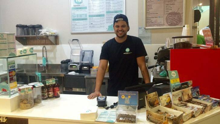 Manager and co-owner of Nutrition Station Aidan Gordon behind the counter of the Canberra store. Photo: Jil Hogan