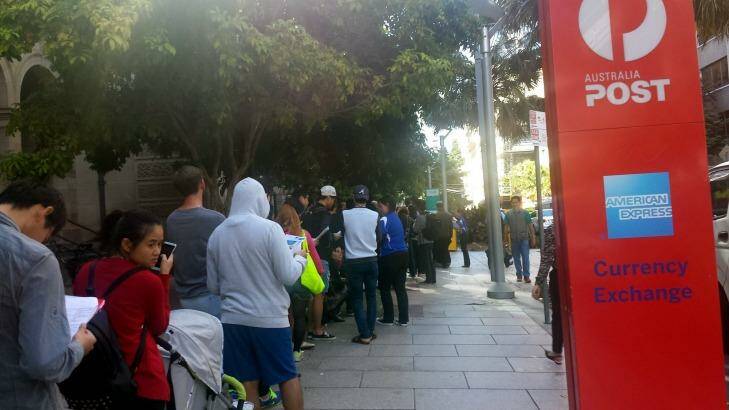 A queue 400 metres long has formed outside the Brisbane CBD Apple store. Photo: Kristian Silva