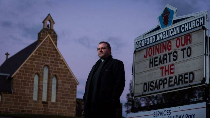 Anglican priest Father Rod Bower with the sign in front of his Gosford church which frequently features messages critical of immigration and asylum seeker policy. 7 July 2014 Photograph by Jon Reid Photo: Jon Reid