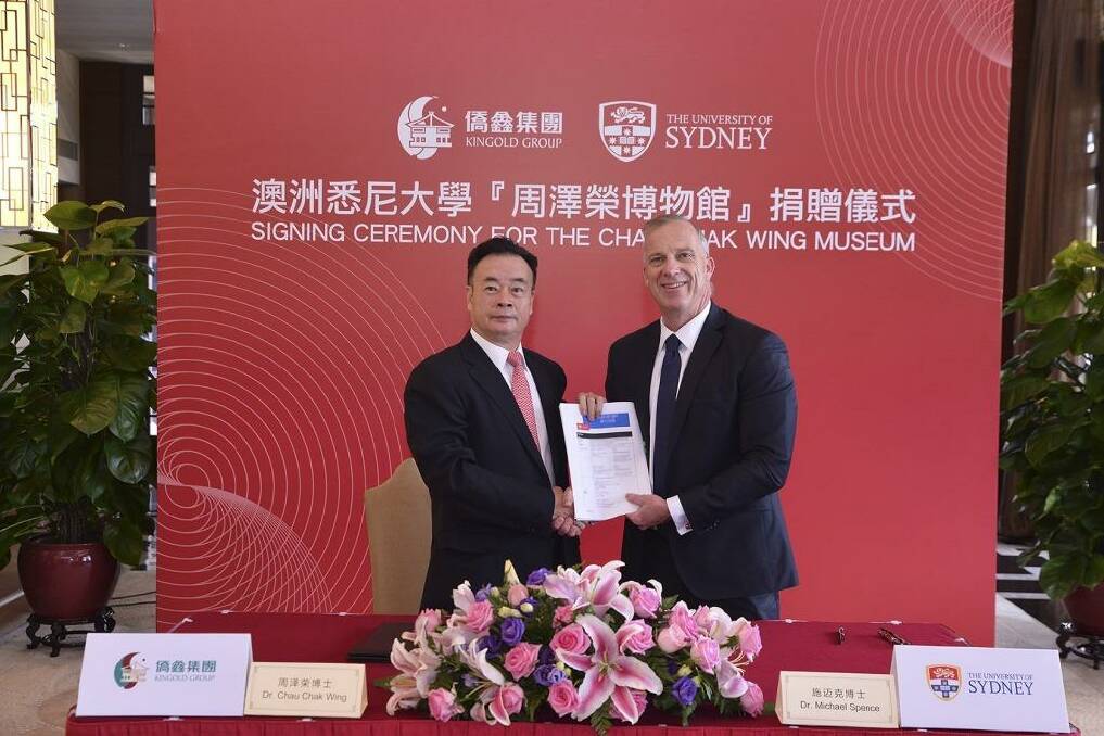 Dr Chau Chak Wing and vice-chancellor of the University of Sydney Dr Michael Spence in Guangdong, China, shaking hands on the gift to build the Chau Chak Wing Museum. 
