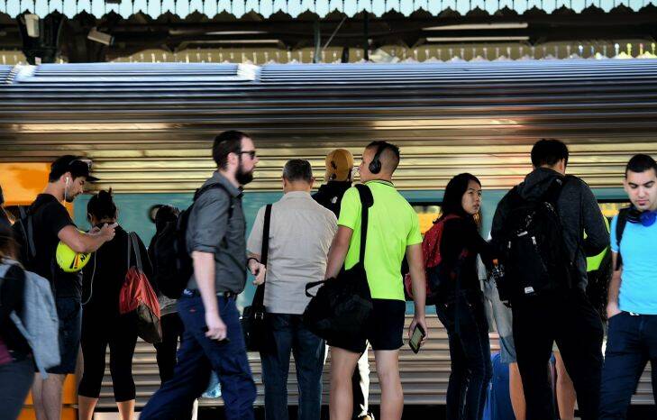 Commuters wait for the train at Strathfield station as timetable changes and shortage of train drivers has forced some services to be cut. Strathfield, Sydney. 15th January, 2018. Photo: Kate Geraghty