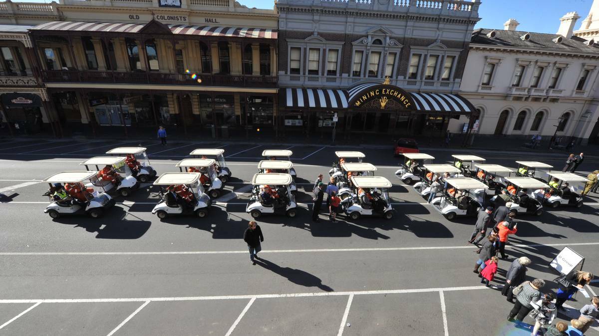 BALLARAT: SES members prepare to escort veterans in golf buggies in the 2014 Anzac Day march. Photo: Jeremy Bannister, The Courier.