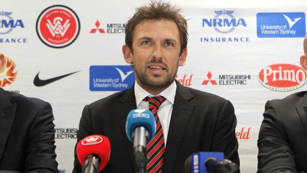 Staying: Wanderers coach Tony Popovic addresses the media after announcing he will remain with the club for another three years. Picture: Gene Ramirez 
