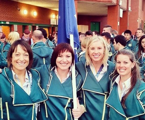 Peta Mullens, third from left, with Aussie flag bearer Anna Meares before the opening ceremony.