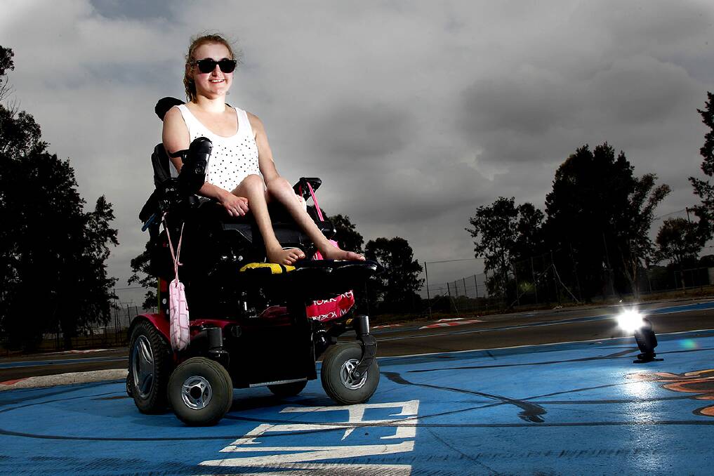 Northcott Disability Services client Ashleigh McDonald is taking part in a newly organised wheelchair racing activity at Whalan Reserve. Photo: Geoff Jones
