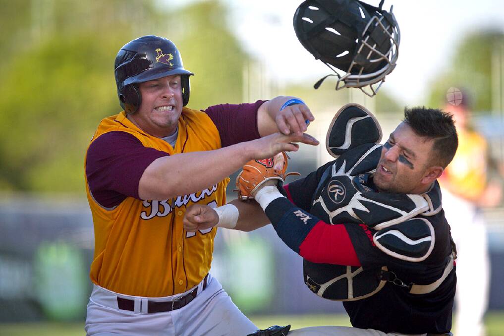 Guy Edmonds makes a play for home plate running into catcher Andrew Azzopardi during the State Baseball League Major Semi Final between Baulkham Hills and Blacktown. Photo: Geoff Jones