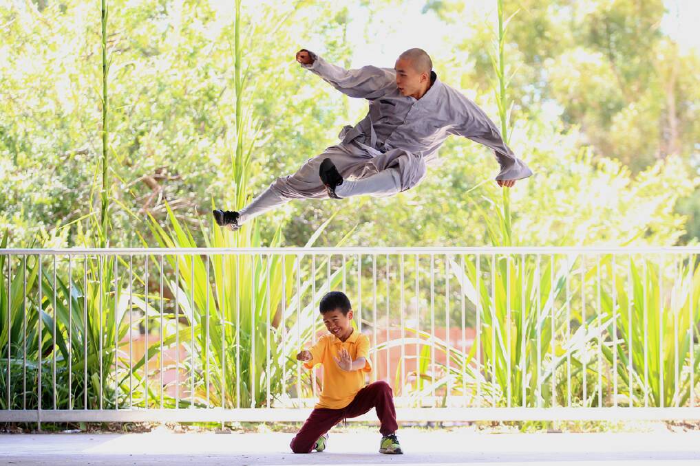 Shaolin monk Yan Lan Shi displays his skills to students from Lansvale Public School. Photo: Wesley Lonergan