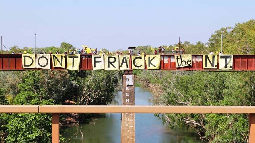 A protest against the development of an onshore gas industry in the NT, using the century-old railway bridge over the Katherine River.