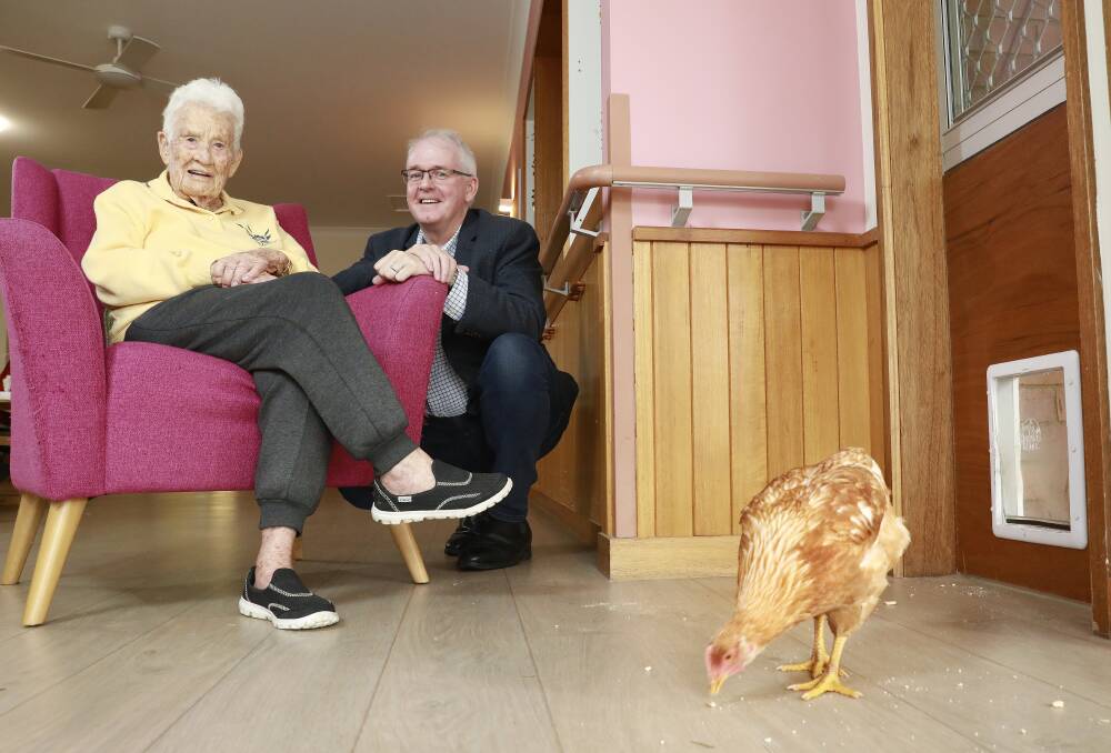 ALL CHICKENS WELCOME: Lutheran Service Immanuel Garden resident Myrle Eldershaw with Lutheran Services CEO Nick Ryan and one of the friendly neighbourhood chickens. Photo: Claudia Baxter