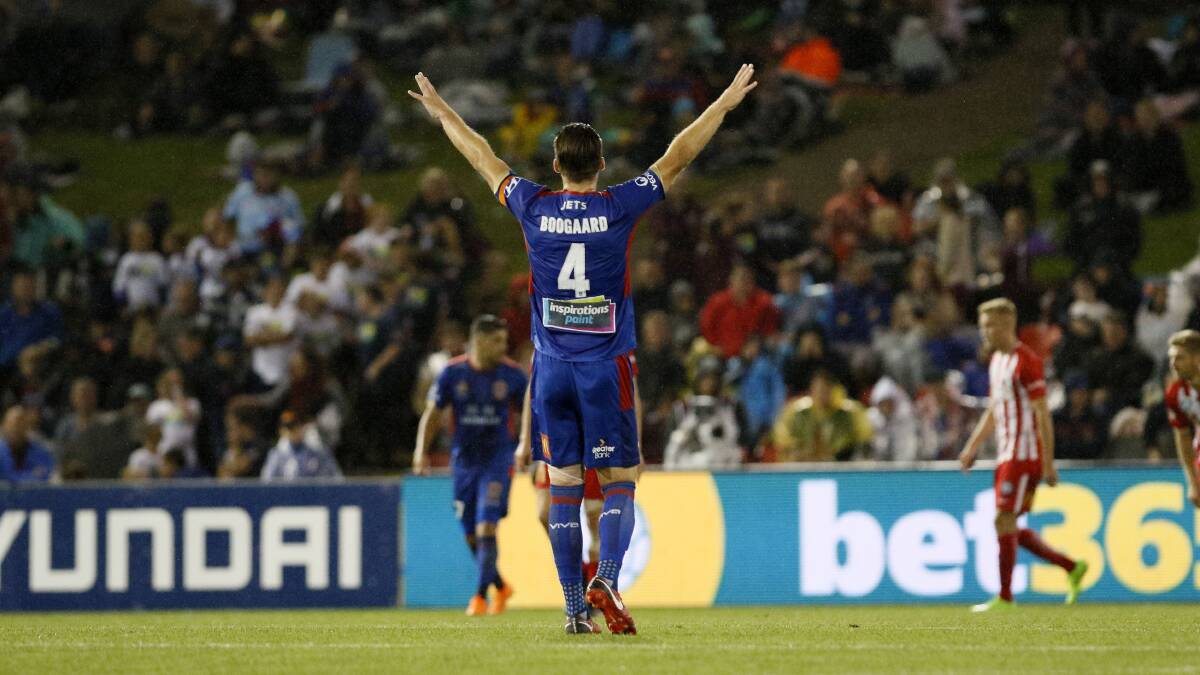 HOME ADVANTAGE: Nigel Boogaard raises his arms in triumph after the Jets' 2-1 win over Melbourne City on Friday night. The Jets will host the A-League grand final at McDonald Jones Stadium next Saturday. Picture: Darren Pateman