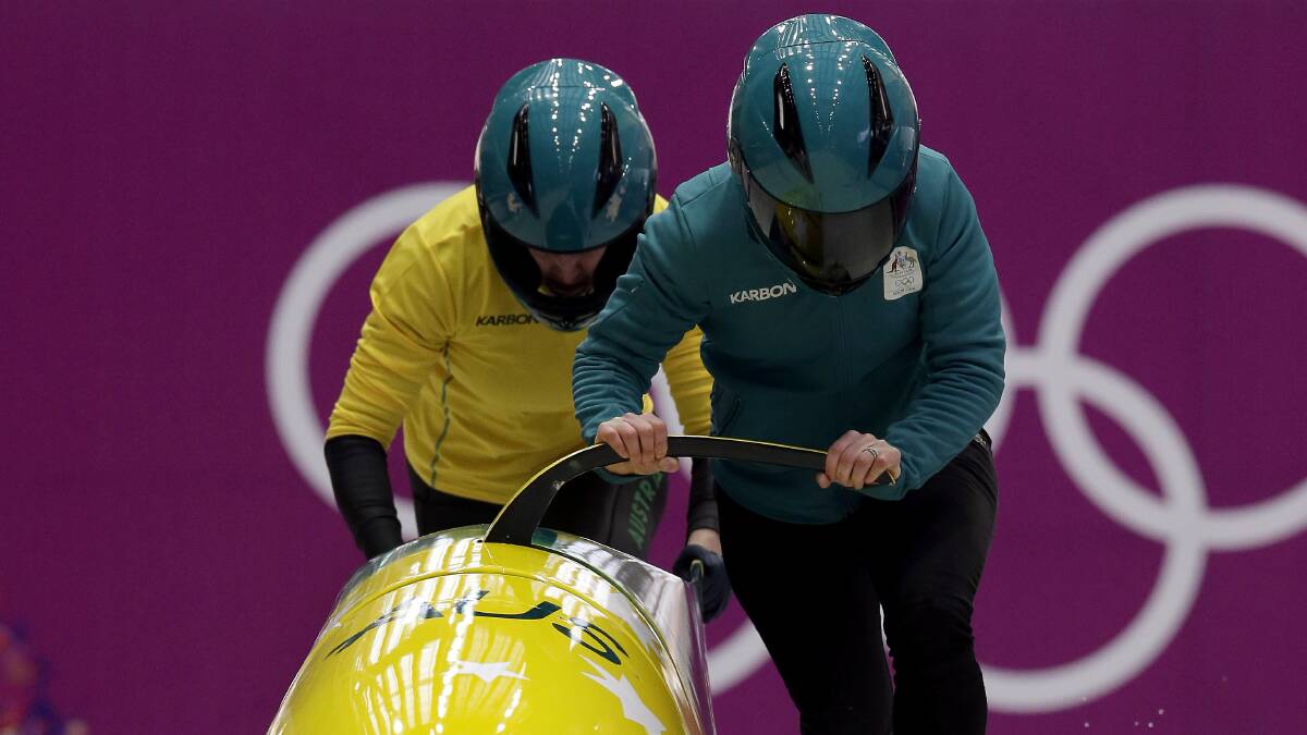 Winter dreams: Astrid Radjenovic, right, and Jana Pittman of Australia start for a training session for the women's bobsleigh at the 2014 Winter Olympics. Picture: AP