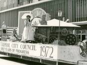 Liverpool City Council float participating in the Liverpool Festival of Progress of 1972 as it moves along Macquarie Street, Liverpool. A banner on the side of the float reads "1872 Liverpool City Council 100 years of progress 1972. Liverpool City Library Heritage Collection.