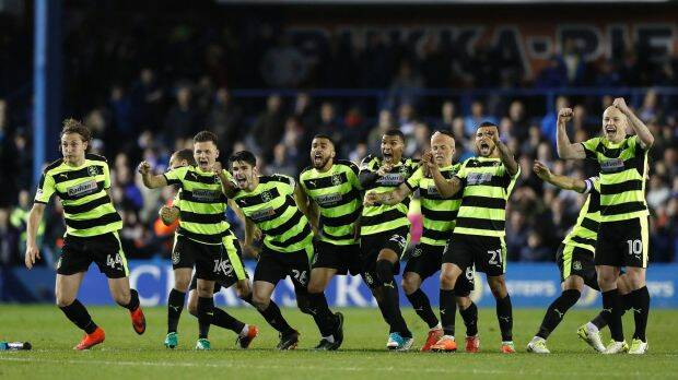 Huddersfield Town's players celebrate their victory. Photo: AP