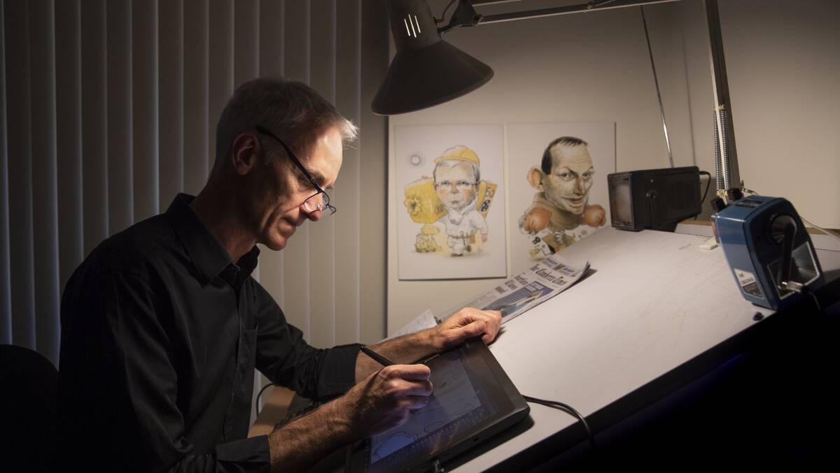 Cartoonist David Popeat work at The Canberra Times. Photo: Sitthixay Ditthavong