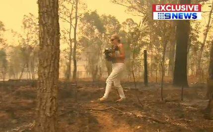 Toni Doherty rescues Ellenborough Lewis from the fires near Long Flat. Photo: Nine News.
