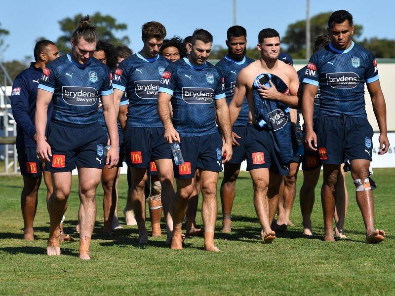 James Tedesco (c) leads the NSW State of Origin squad during an "earthing exercise" in Kingscliff.