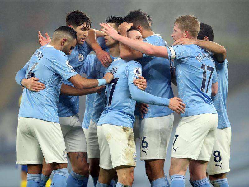 Manchester City players celebrate a Premier League earlier goal this week.