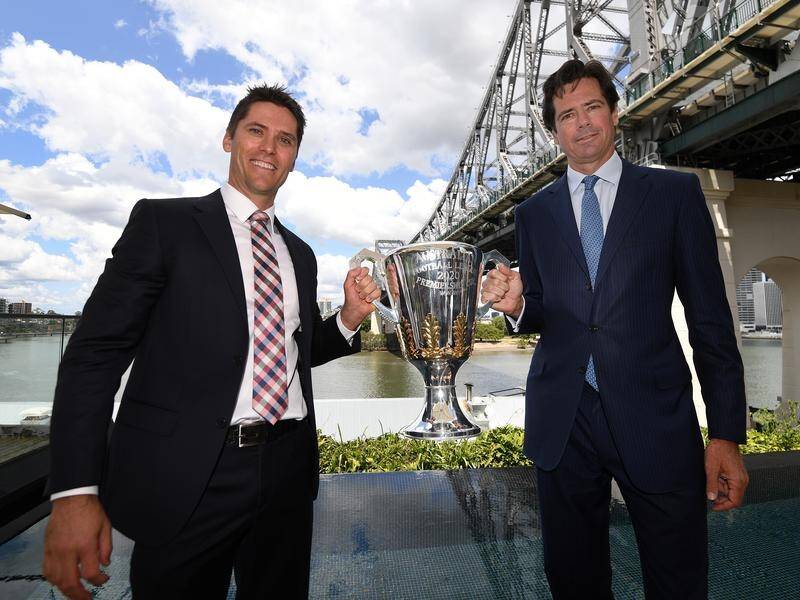Gillon McLachlan (r) and ex-Brisbane Lions player Simon Black with the AFL trophy on Monday.