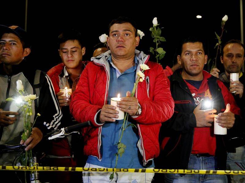 Colombians hold a candlelight vigil at the police academy hit by a deadly terrorist attack.