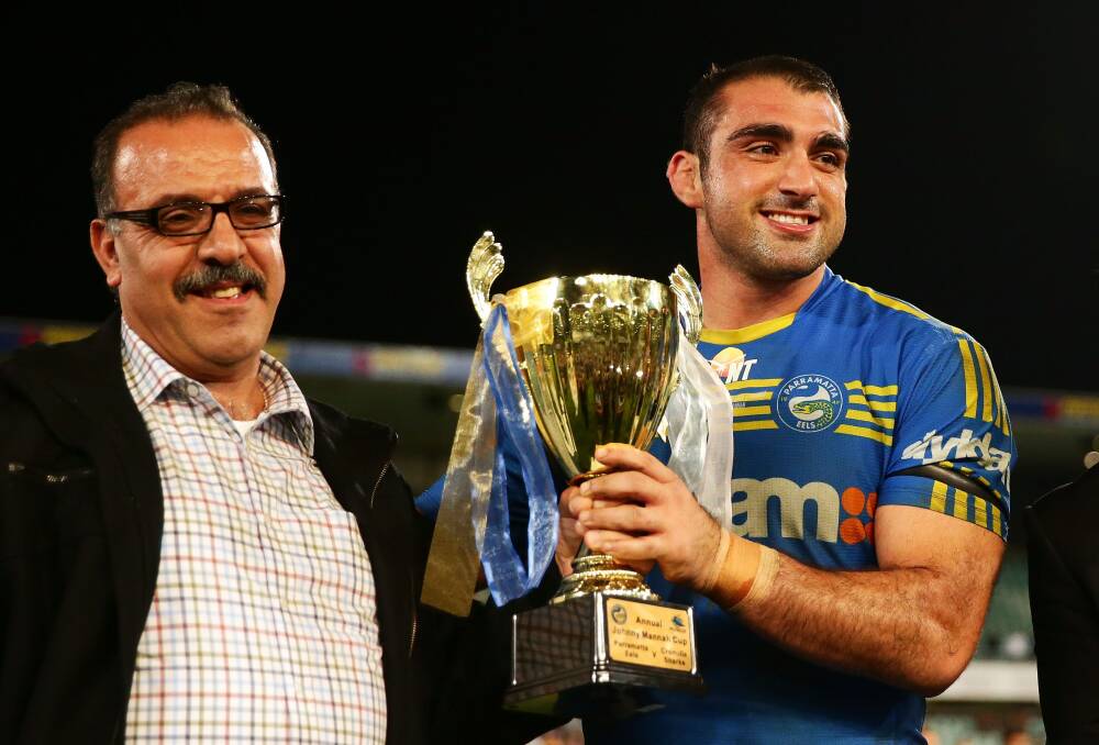 SYDNEY, AUSTRALIA - MAY 12:  Tim Mannah of the Eels holds the Jon Mannah cup with his father Fred Mannah after victory in the round nine NRL match between the Parramatta Eels and the Cronulla-Sutherland Sharks at Pirtek Stadium on May 12, 2014 in Sydney, Australia.  (Photo by Matt King/Getty Images) Johnny Mannah Cup 2014. Picture: Getty Images