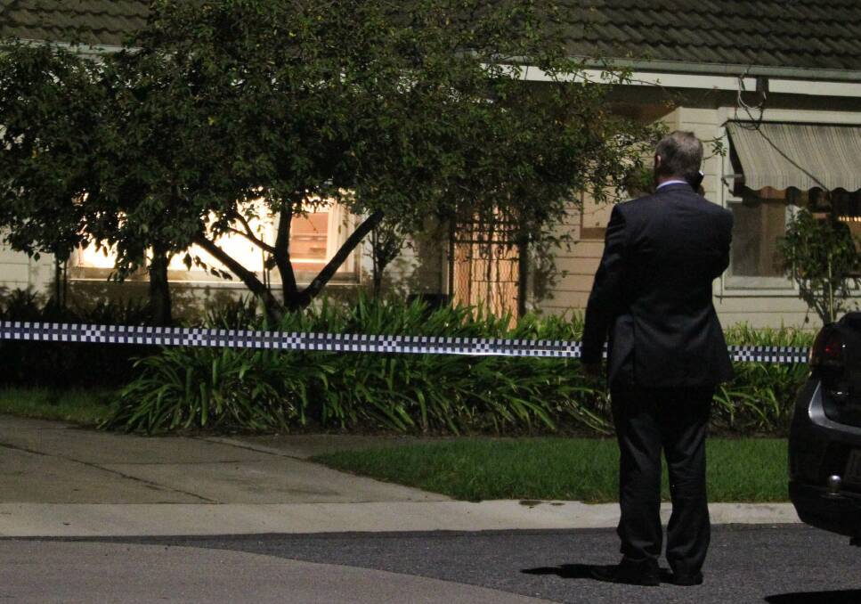 ON SCENE: A Homicide Squad detective stands outside the Chilcott family's home following the murder-suicide, which left four young children orphaned. 
