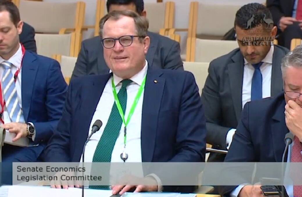 Australian Taxation Office Commissioner Chris Jordan presents his opening statement to the Senate economics committee alongside Finance Minister Mathias Cormann.